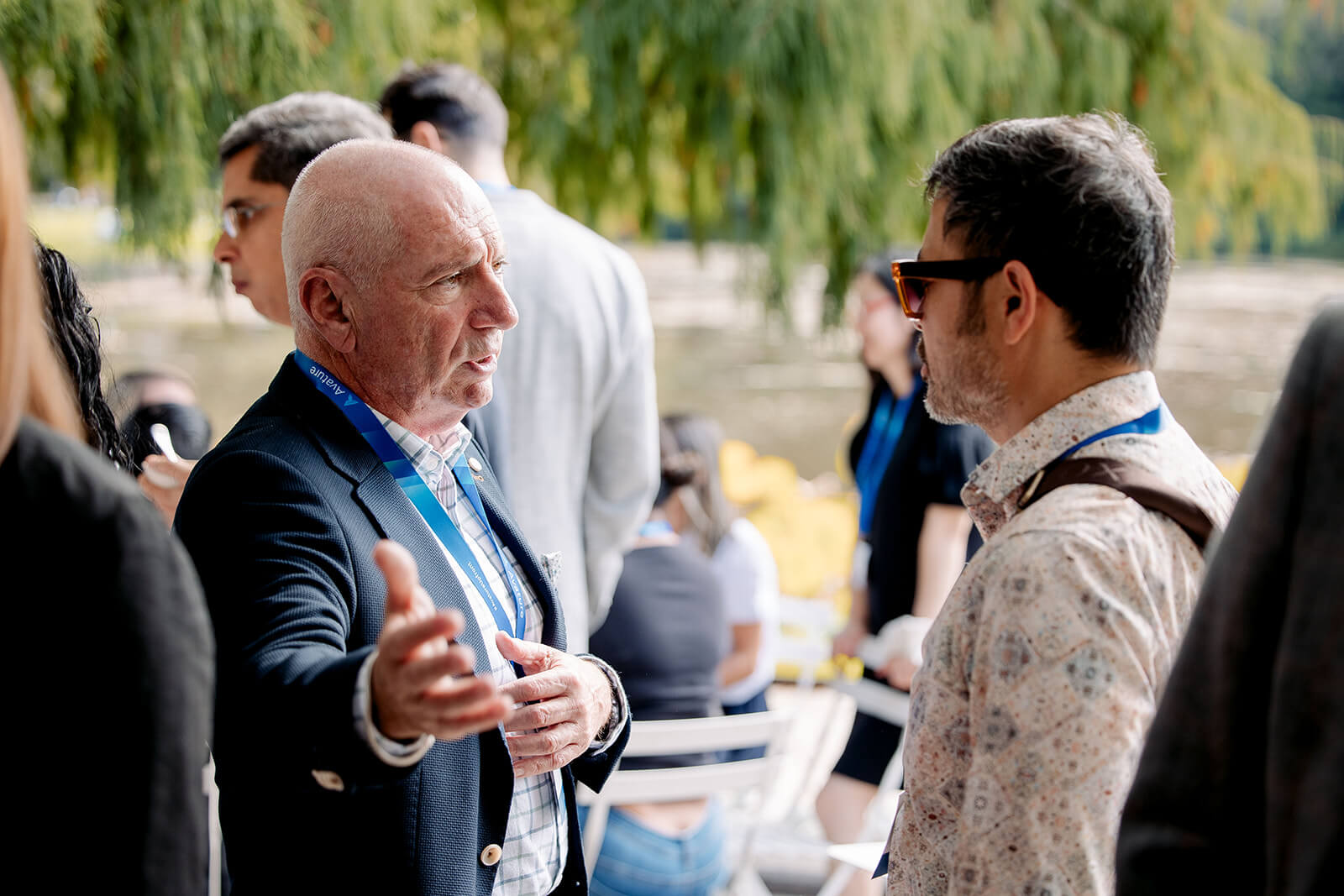 Two HR leaders by a lake continue the discussion on the latest issues impacting HR at AvatureUpfront.